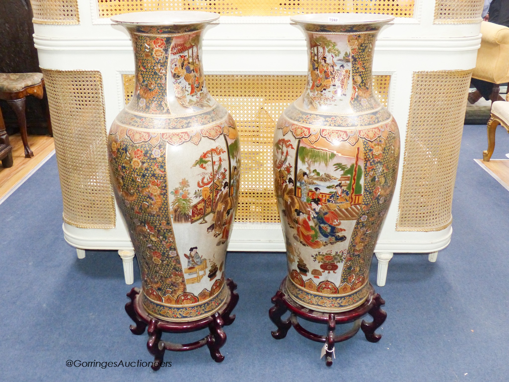 A pair of large Japanese vases, on hardwood stands